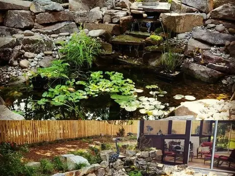 Backyard pond with a stacked-stone waterfall, lily pads and a seated statue, above a view of the finished rock garden