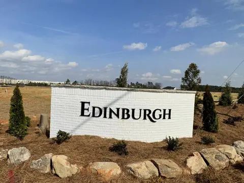 Edinburgh entrance sign surrounded by boulders, shrubs and pine straw