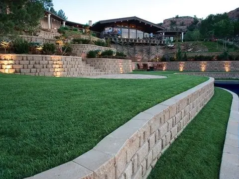 Segmental block retaining wall and lawn beside a pond
